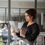 A woman happy about being part of a UCaaS wholesale partner program for a Cloud Phone Systems