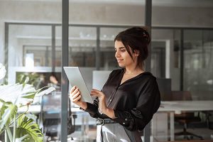 A woman happy about being part of a UCaaS wholesale partner program for a Cloud Phone Systems
