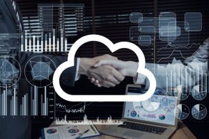 Cloud Communications Partner with a virtual cloud icon and reports over two business people shaking hands