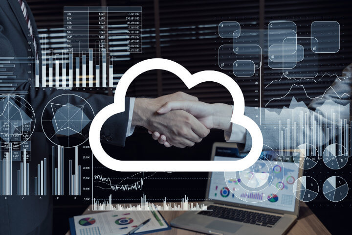 Cloud Communications Partner with a virtual cloud icon and reports over two business people shaking hands