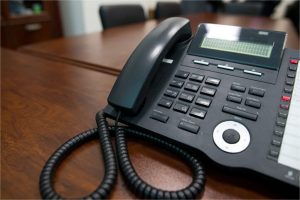 wholesale UCaaS partnership helps migrate communications platforms like this traditional business phone on a conference table