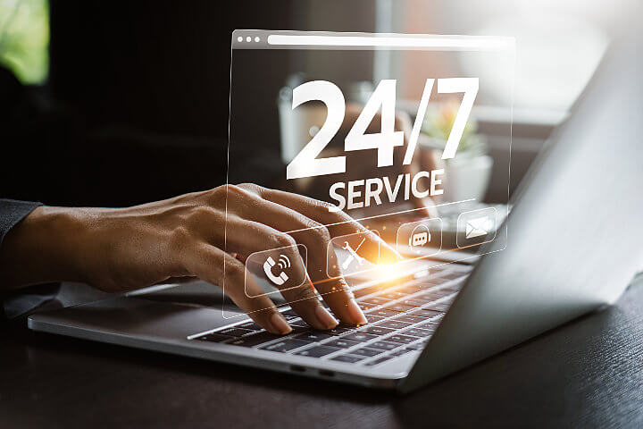 Woman using a laptop with 24/7 U.S.-based VoIP support