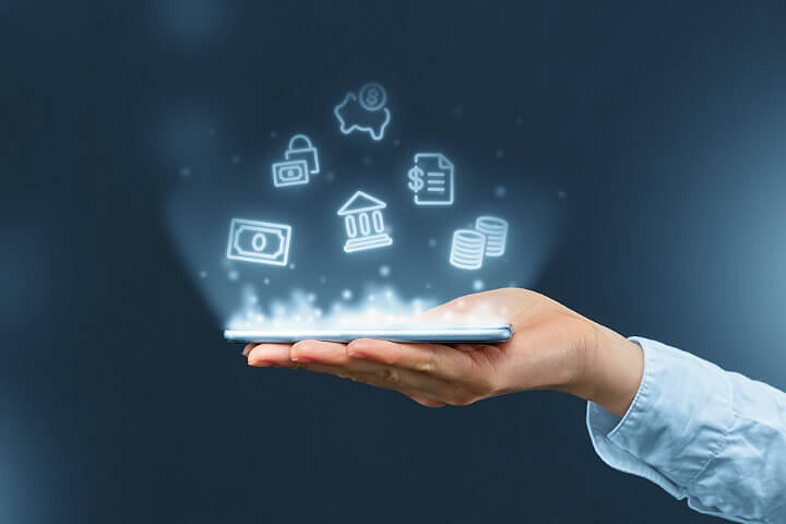 Hand holding a mobile phone showing virtual icons above it for cloud phone systems