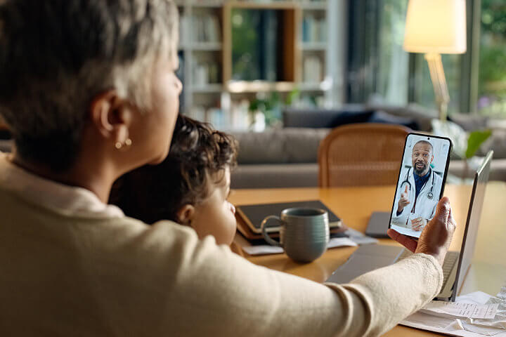 Grandmother and grandson using VoIP for healthcare to speak with a doctor