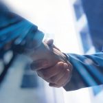 Close up of two business men shaking hands to represent FluentStream's partner program