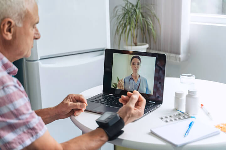 Doctor using a modernized business communication system called telehealth to monitor their patient