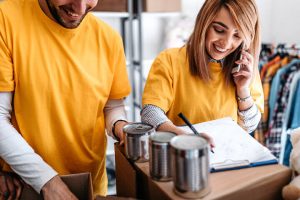 The best phone systems for nonprofits for these two people boxing up can food