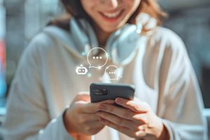 Closeup of young woman texting on her phone