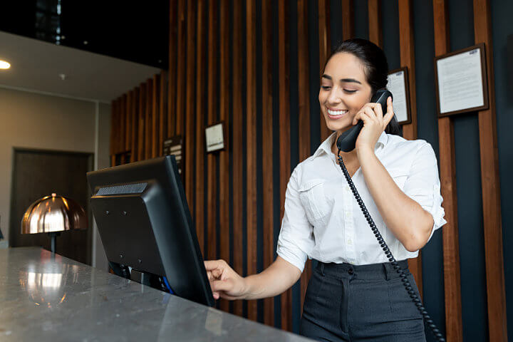 Woman at desk using UCaaS for small businesses